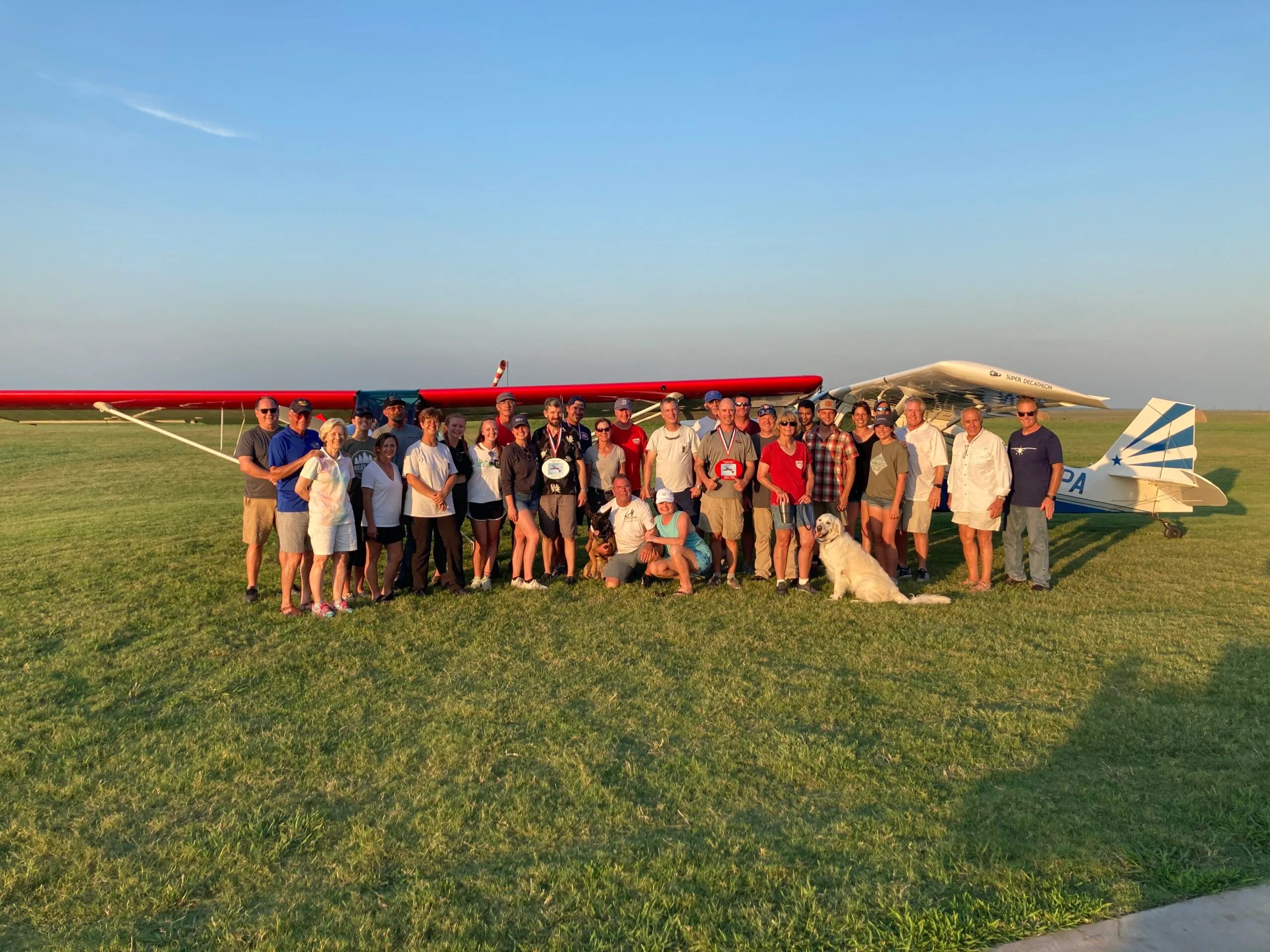 a group of people standing in front of an airplane